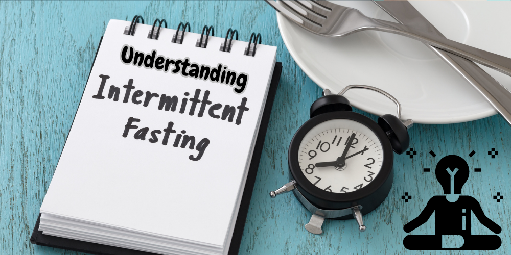 A note pad with the words understanding intermittent fasting and an alarm clock next to it.