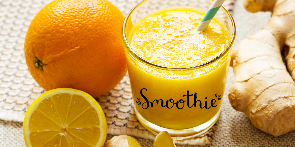 A smoothie with a straw next to an orange a lemon a piece of ginger.