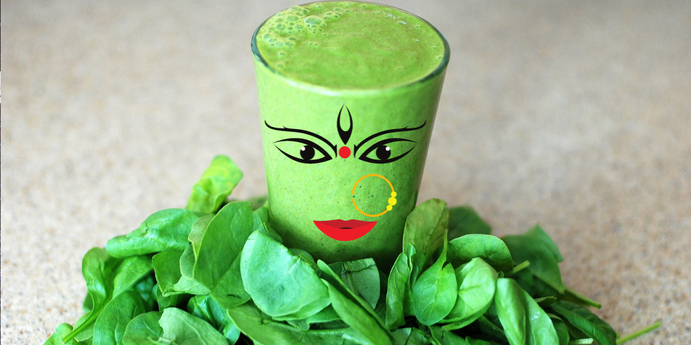 A green smoothie with a goddess face on the glass with leafy greens around it. These drinks are great for weight loss especially belly fat.