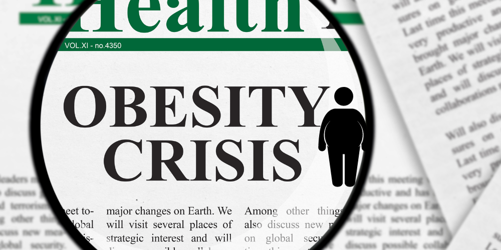 A newspaper with the headline obesity crisis with a graphic of a fat man.
